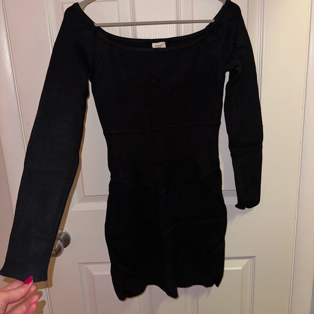 Fitted off the shoulder black mini sweater dress.